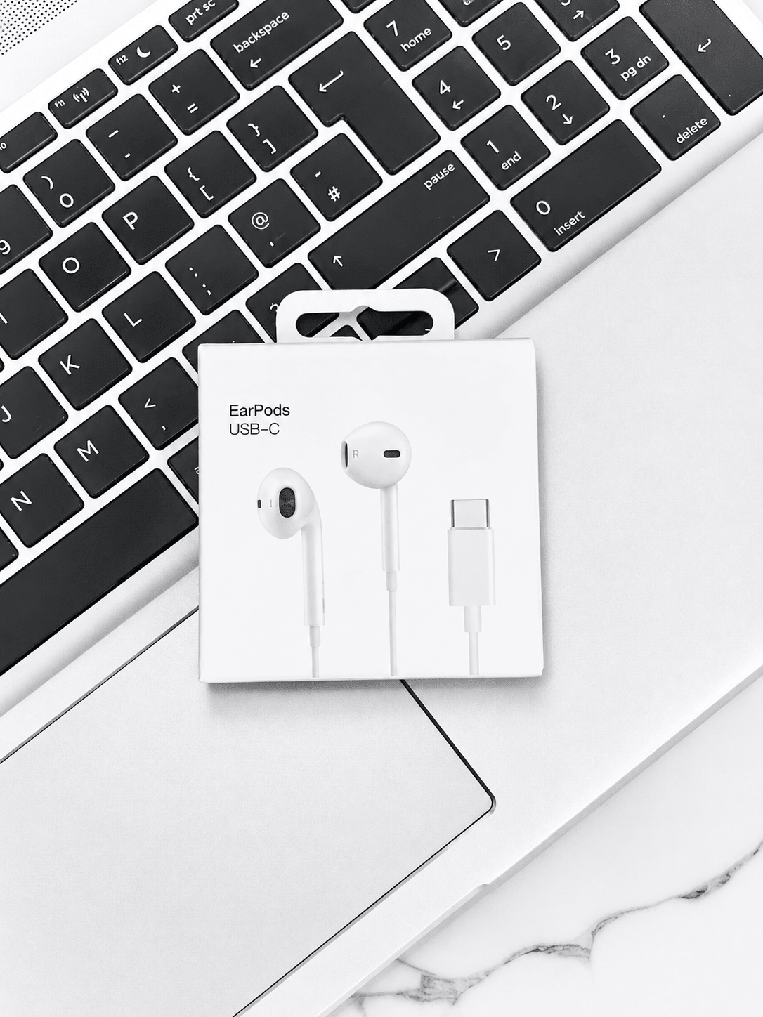 Apple EarPods USB-C earphones on laptop